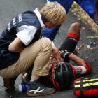Richie Porte of Australia riding for BMC Racing Team is attended to by medical staff after...