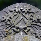 A flowers and bow design on a headstone, carved from Italian marble. The headstone would have...