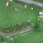 A view of the SH87 culvert blocked after July floods, and water lying in the drain downstream....