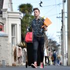 Matthew Schep, co-leader of Students for Environmental Action, helps collect rubbish in Castle St...