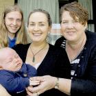 Jenny Pascoe (centre) was helped when she was struggling at the supermarket with her baby Olli by...