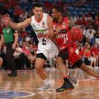 Jarrod Kenny (left), playing for the Cairns Taipans, keeps Bryce Cotton of the Wildcats in check...