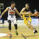 Otago Nuggets guard Benoit Hayman attempts to move the ball around Josh Boxham, of the Nelson...