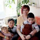 Danni Rasmussen holds Andre, 4, with Avie Avana, 2, and Alize, 11. They hope to soon embark on a...