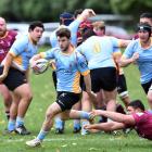 University halfback Kieran McClea evades a tackle during a match against Alhambra-Union at Logan...