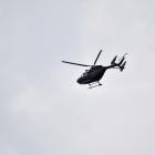 A helicopter takes part in the operation at Bluff Harbour today. Photo: Laura Smith