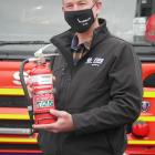 Fire and Emergency New Zealand community risk manager James Knapp holds a fire extinguisher, one...