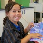 Carisbrook School pupil Paradise Mercer (8) takes a break from painting during the Painted Poems...