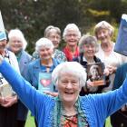 Chota Moore and members of the book club hold up one of the first and most recent books read by...