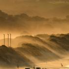 Early morning sunlight through sea mist at Middle Beach. Photo: Stephen Jaquiery