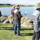 Eyes on the lake . . . Skippers watch their one metre long radio controlled sail boats manoeuvre...