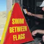 Dusting off . . . Waikuku Surf Life Saving Club life guard Andy MacFarlane gears up for the new...