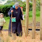 Hinerangi Ferrall-Heath blesses the Karitane playground, accompanied 
...