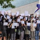 Protesters held white A4 paper as a symbol of defiance against censorship by the Chinese...