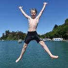 Tom Rae (12) of Dunedin jumps into the water off a jetty at Back Beach, Port Chalmers. Photo:...