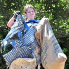 Connor Fraser (13) holds up some of the findings from the Tomahawk Beach clean-up yesterday....