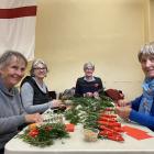 Working together at HMNZS Toroa on Monday to make some of the 4000-plus posies laid at the...