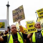 Anti-monarchy demonstrators at The Mall in London hold placards ahead of King Charles’ procession...