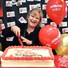 Anne Jaquiery-Newall cuts the cake to mark World Blood Donor Day at the Dunedin Donor Centre...