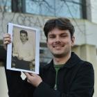 Quinn Hawthorne holds a photograph of his late grandfather outside Otago Museum yesterday. The...