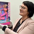 Otago Museum humanities collection manager Anne Harlow shows off a gymnast Barbie from 1993....