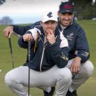 Australian lock Richie Arnold (rear) gives team-mate Dylan Pietsch a line on his putt during a...