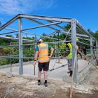 Workers begin assembling the steel frame of a new preschool in the village of Amelvet on Malekula...