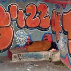 A homeless person sleeps in the open basement below social housing provider Kāinga Ora, in Moray...