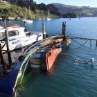 A derelict steel boat has sunk at the wharf in Carey’s Bay. PHOTO: STEPHEN JAQUIERY