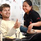 Andrew Searle, 25, gives blood with a helping hand from nurse Issa Galagala at NZ Blood Dunedin...
