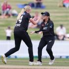 New Zealand's Hannah Rowe and Suzie Bates celebrate the wicket of England's Tammy Beaumont. Photo...