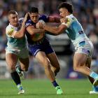 Addin Fonua-Blake of the Warriors is tackled during the Anzac Day clash against the Titans in...