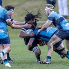 Arrowtown’s Aidan Conrad-Hinga feels the impact of a crunching tackle from Wakatipu’s Josh...