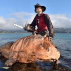 Waitati-based chainsaw carver Adrian ‘‘A.d’’ Pugh poses with one of his creations Henrietta the...