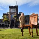 Larnach Castle sales and marketing manager Jo van der Linden with a rimu chair made for William...