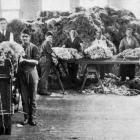 Back when wool was £1 a pound, graders at Dunedin wool dealers J.K. Mooney and Co case wool for...