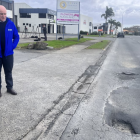 Simeon Brown and Christopher Luxon survey potholes at an earlier announcement. Photo: RNZ