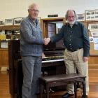Oamaru Variety Entertainment Club president Ray Walker (left) presents the club’s piano to Oamaru...