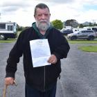 Craig Reeves show the eviction notice that last year moved him out of the Taieri A&amp;P...