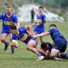 Dunedin forwards Hame Toma (centre) and Hunter Fahey (right) tackle Taieri’s Josh Whaanga during...