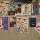 Posters of Iranian presidential candidates Masoud Pezeshkian and Saeed Jalili displayed in a...