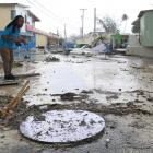 A man walks along a debris-filled street in the Hastings neighbourhood after Hurricane Beryl...