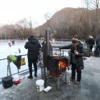 Warming up beside the ice. A family night at the Bush Creek ice rink in Arrowtown proved popular...