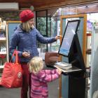 Cromwell library patrons Nita Smith and daughter Stella Parsons, 4, both of Cromwell, issue their...