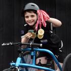 Dunedin frame runner Cooper McLennan,10, holds his collection of gold medals won competing in the...