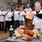 Sue Stockwell wrings out a loaf as Dunedin Craft Distillers celebrate saving 10tonnes of bread...