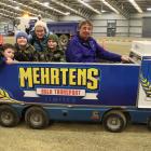 Bob Mehrtens, in the driver seat of his miniature Kenworth truck, is ready to take (from left)...