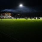 Otago University and Auckland City players stand in a pool of light after the lights at Logan...