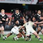 Asafo Aumua of the All Blacks is tackled during tonight's test match between New Zealand and...