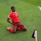 Breel Embolo celebrates scoring Switzerland's first goal as a fan throws a plastic cup during...